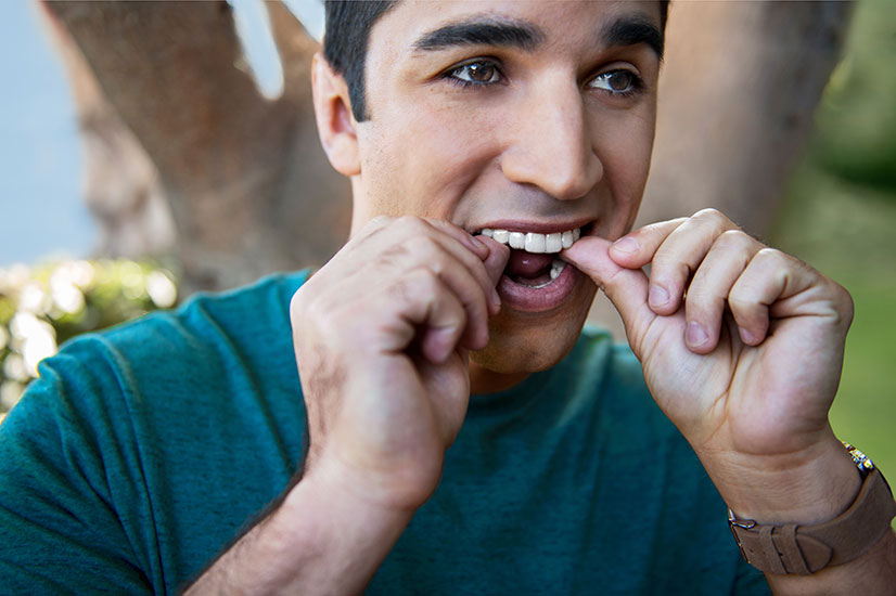 Person clicking in Invisalign braces